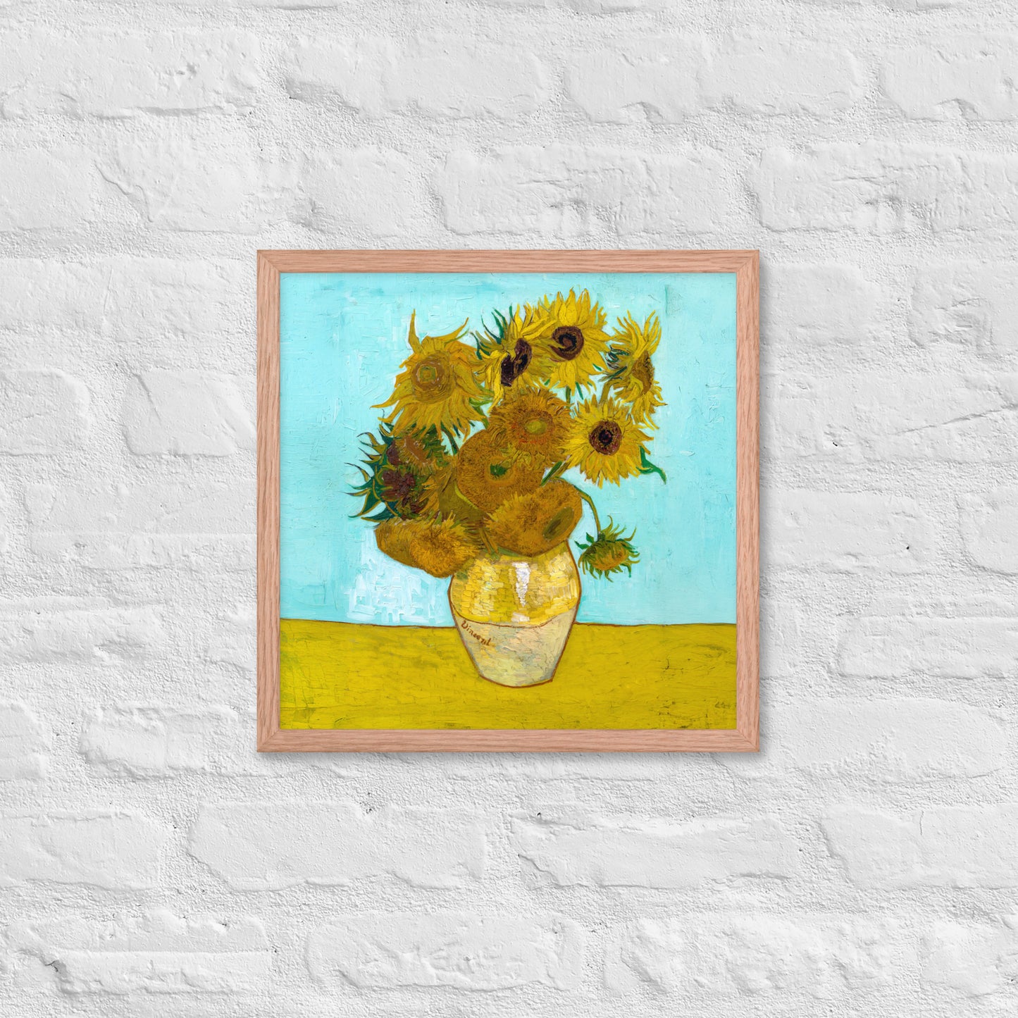 Van Gogh's 'Vase with Twelve Sunflowers' on a 16"x16" red oak framed poster print on a white brick wall.