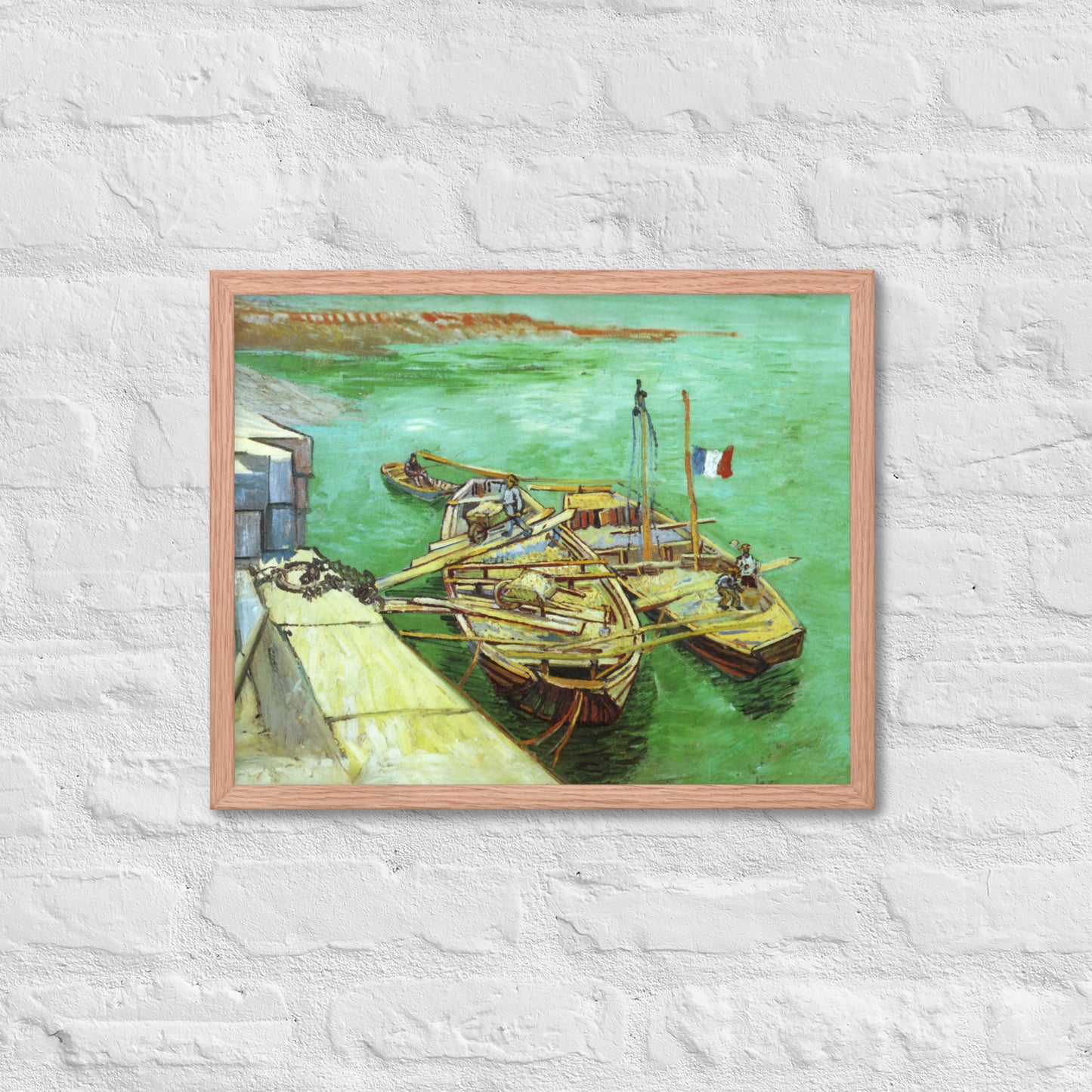 Van Gogh's 'Quay with Men Unloading Sand Barges' on a 16"x20" red oak framed poster print on a white brick wall.