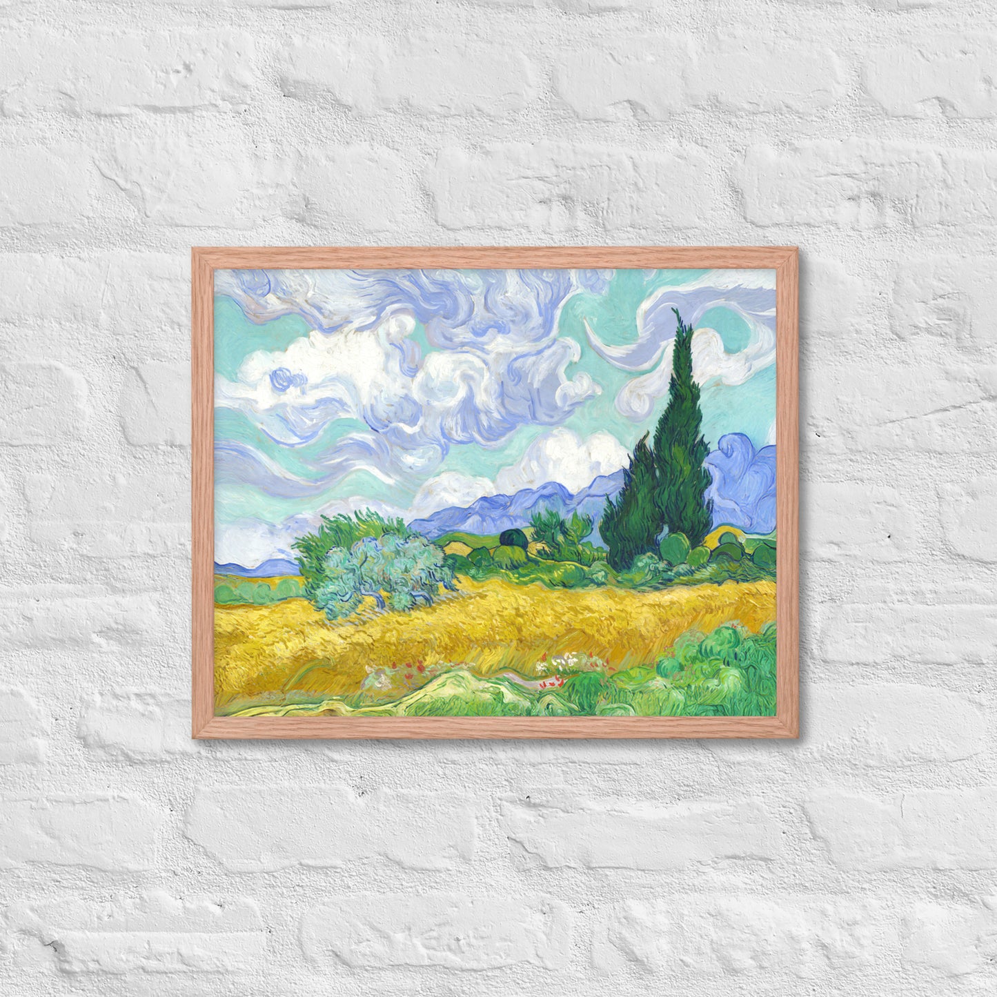 Van Gogh's 'Wheat Field with Cypresses' on a 16"x20" red oak framed poster print on a white brick wall.