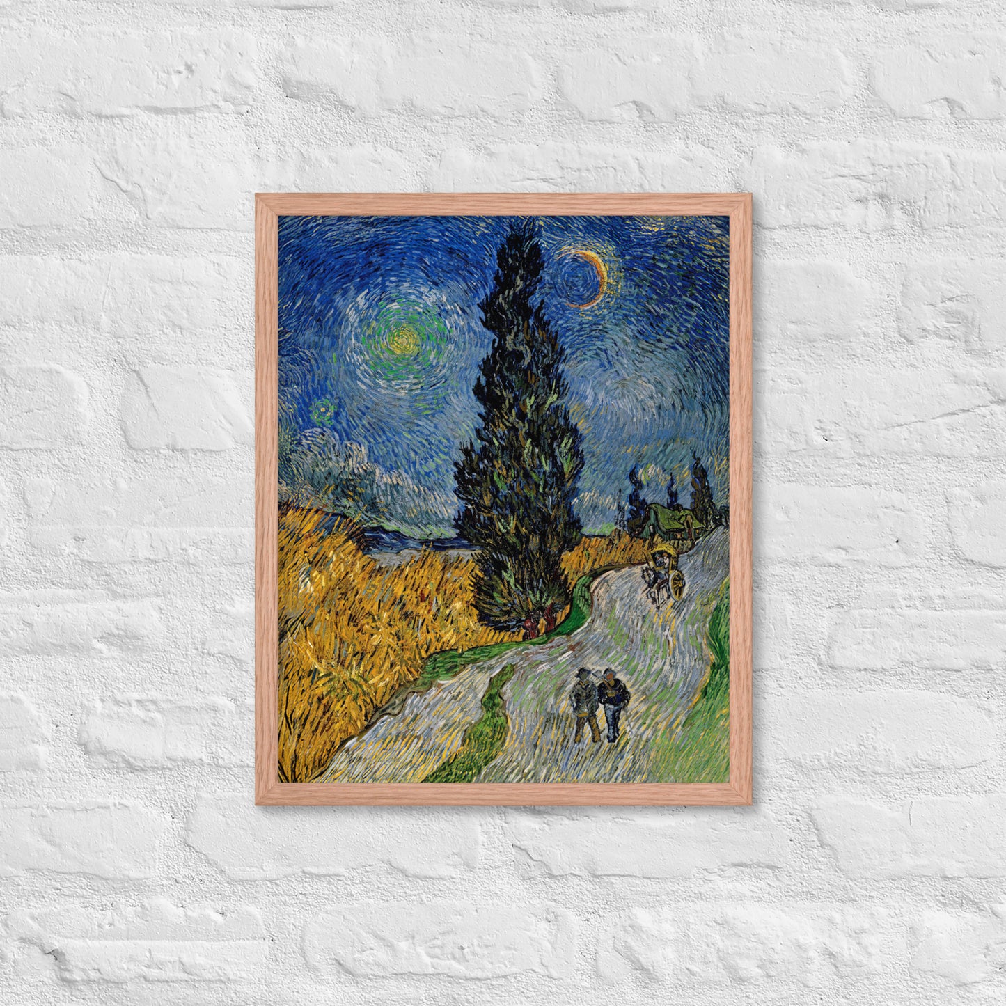 Van Gogh's 'Road with Cypress and Star' on a 16"x20" red oak framed poster print on a white brick wall.