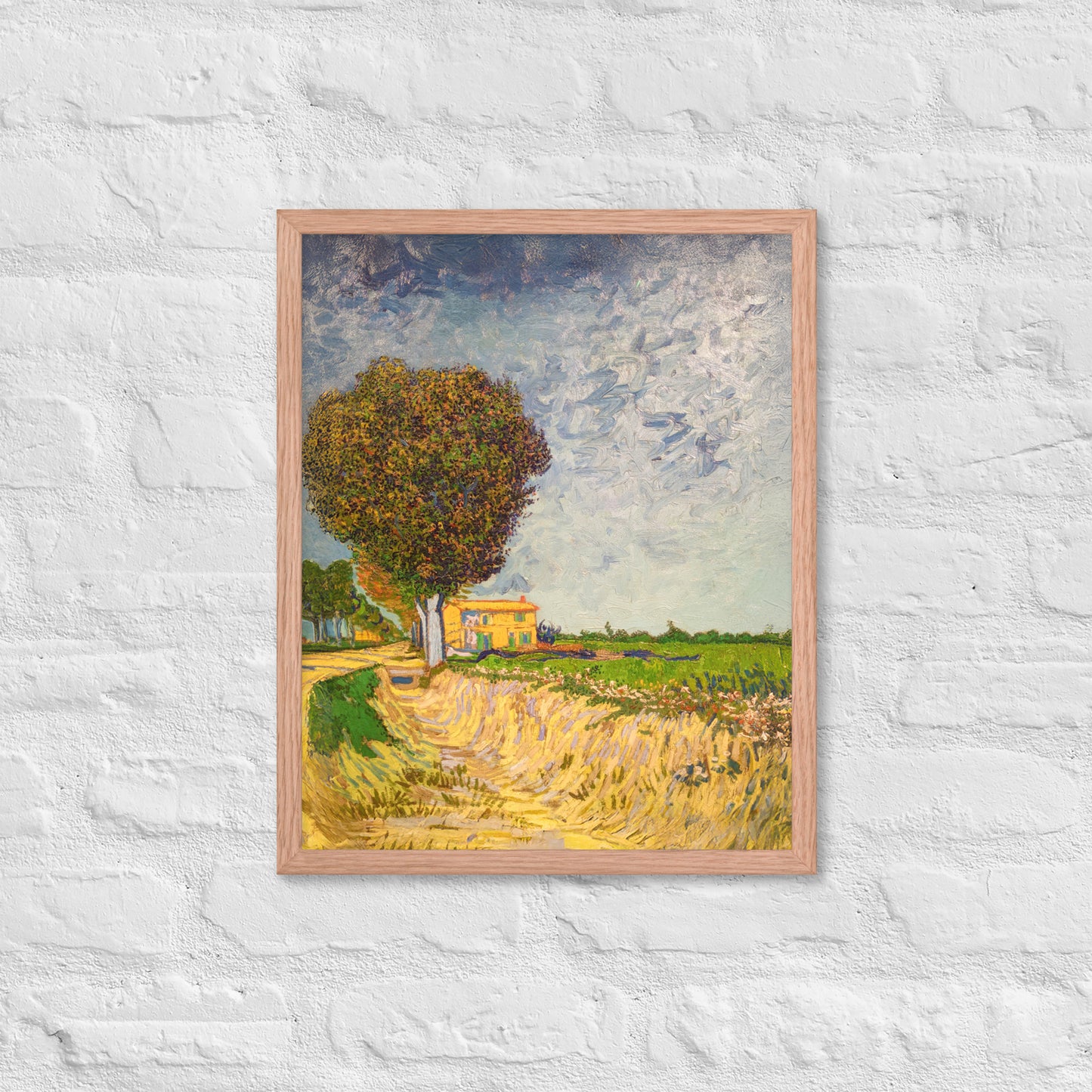 Van Gogh's 'A Lane near Arles' on a 16"x20" red oak framed poster print on a white brick wall.