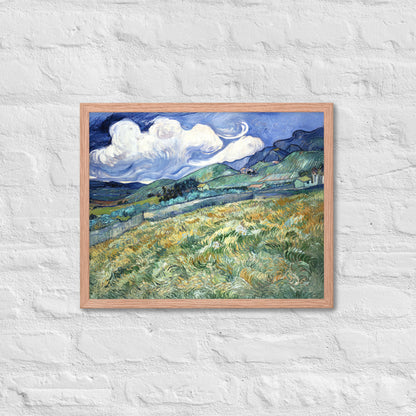 Van Gogh's 'Landscape from Saint-Rémy' on a 16"x20" red oak framed poster print on a white brick wall.