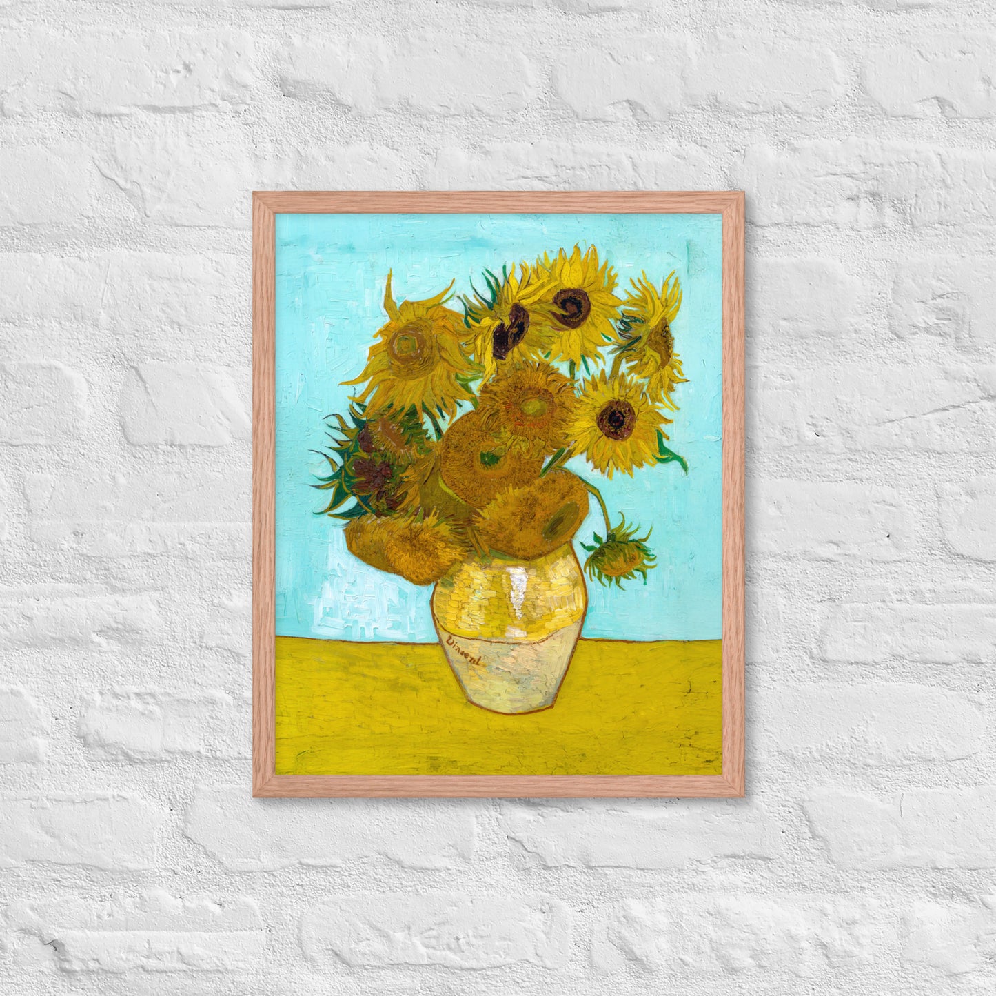Van Gogh's 'Vase with Twelve Sunflowers' on a 16"x20" red oak framed poster print on a white brick wall.