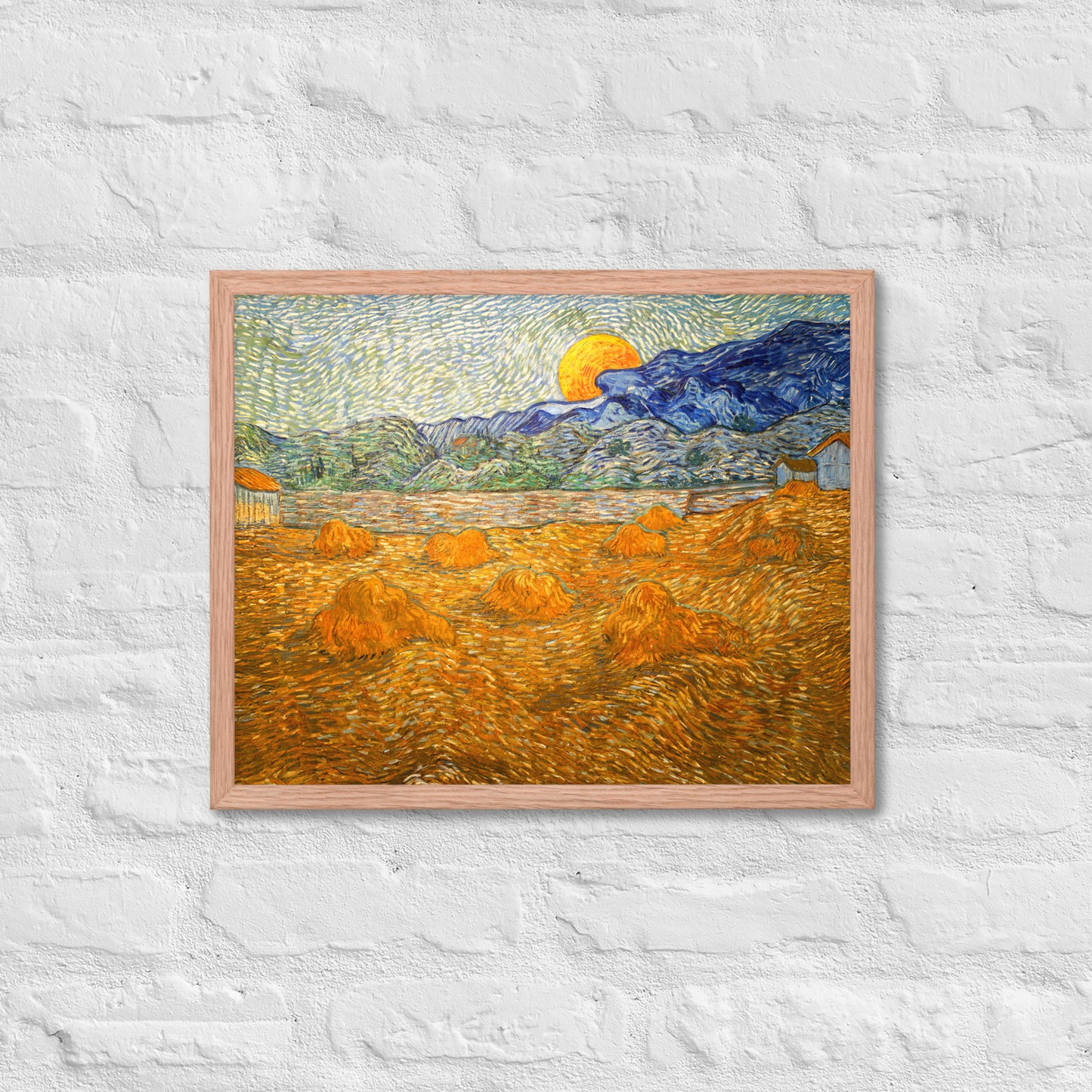 Van Gogh's 'Landscape with Wheat Sheaves and Rising Moon' on a 16"x20" red oak framed poster print on a white brick wall.