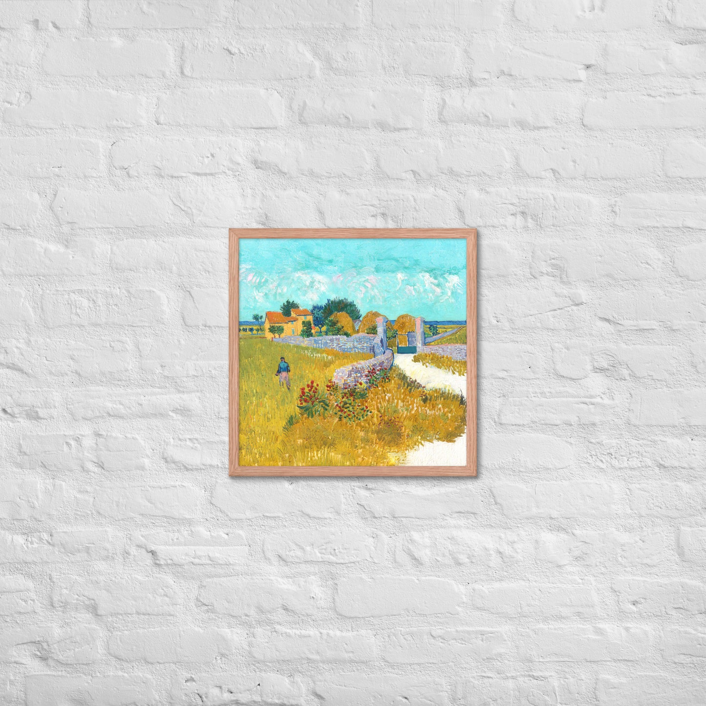 Van Gogh's 'Farmhouse in Provence' on a 18"x18" red oak framed poster print on a white brick wall.