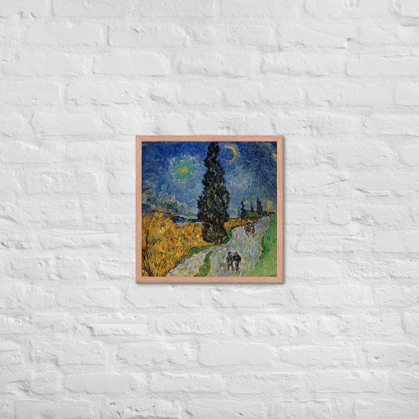 Van Gogh's 'Road with Cypress and Star' on a 18"x18" red oak framed poster print on a white brick wall.
