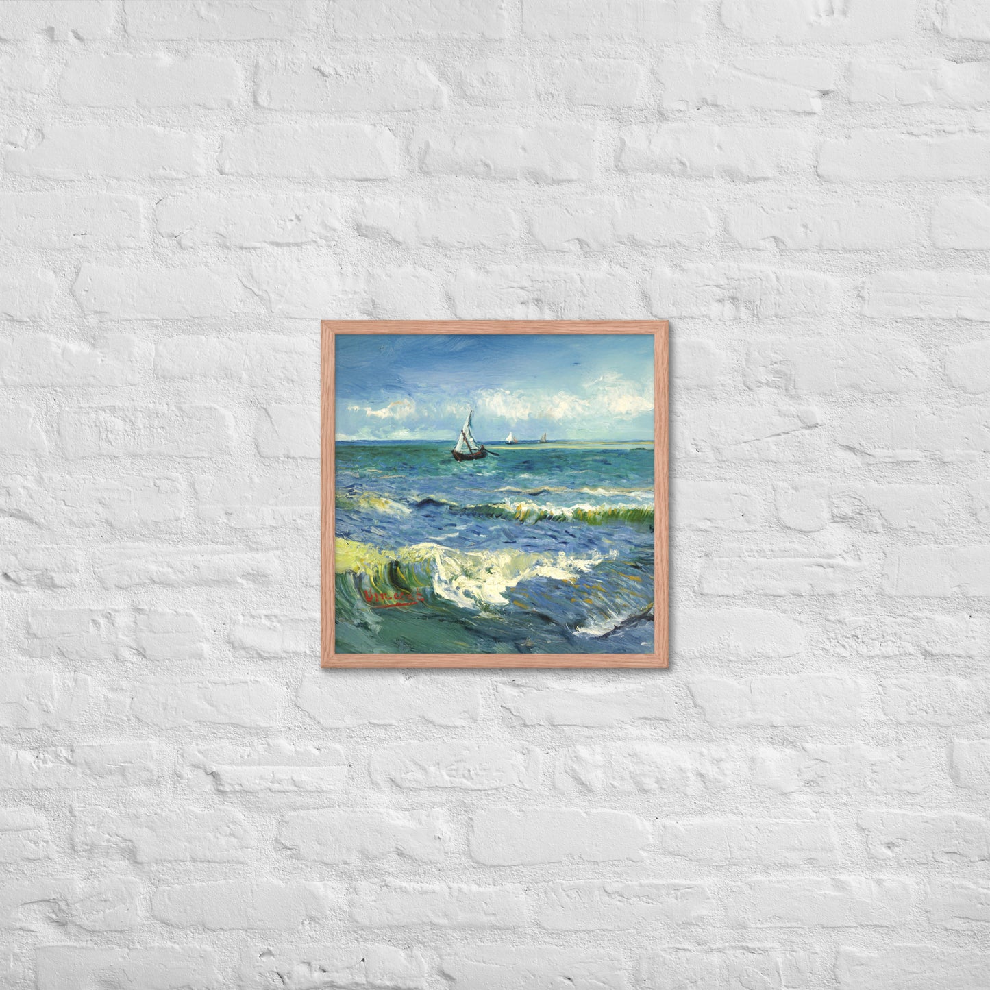 Van Gogh's 'The Sea at Les Saintes-Maries-de-la-Mer' on a 18"x18" red oak framed poster print on a white brick wall.