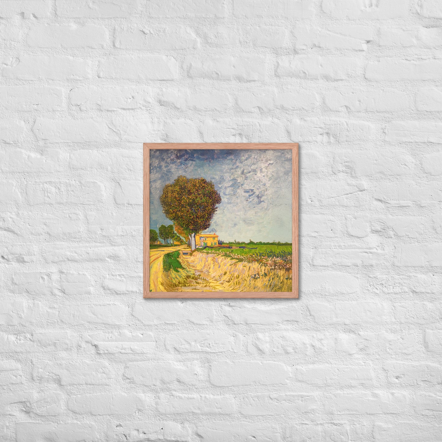 Van Gogh's 'A Lane near Arles' on a 18"x18" red oak framed poster print on a white brick wall.