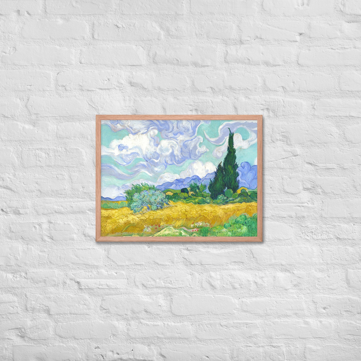 Van Gogh's 'Wheat Field with Cypresses' on a 18"x24" red oak framed poster print on a white brick wall.