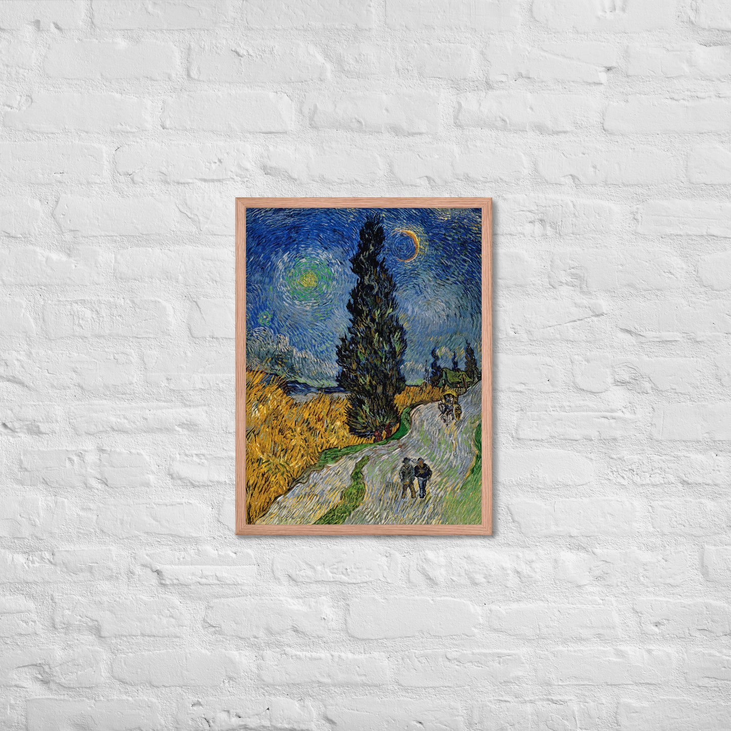 Van Gogh's 'Road with Cypress and Star' on a 18"x24" red oak framed poster print on a white brick wall.