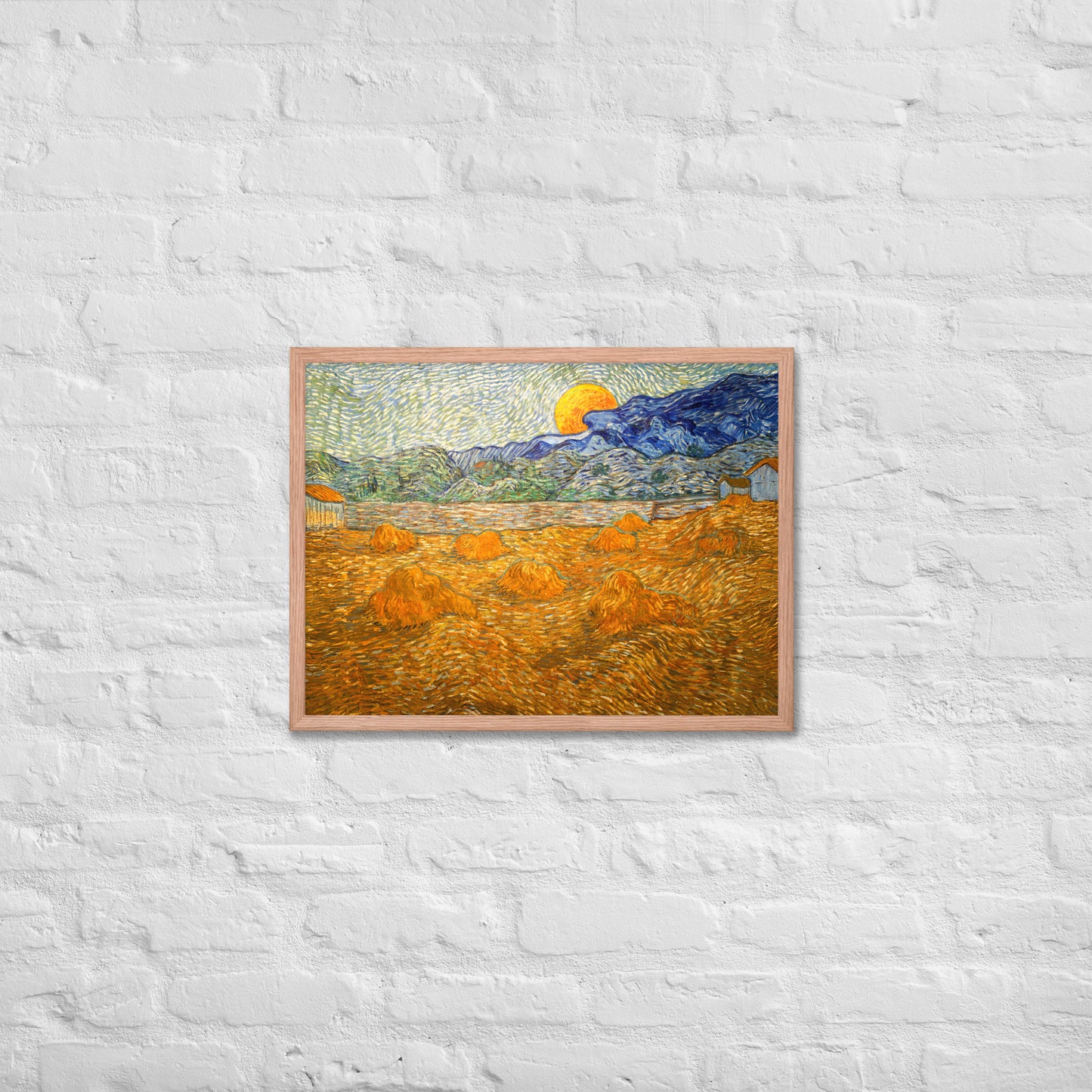 Van Gogh's 'Landscape with Wheat Sheaves and Rising Moon' on a 18"x24" red oak framed poster print on a white brick wall.
