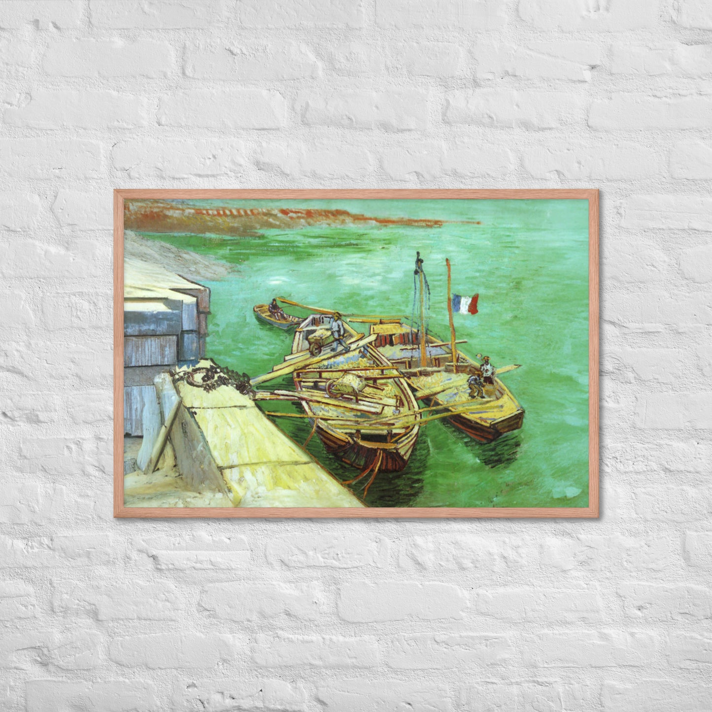 Van Gogh's 'Quay with Men Unloading Sand Barges' on a 24"x36" red oak framed poster print on a white brick wall.