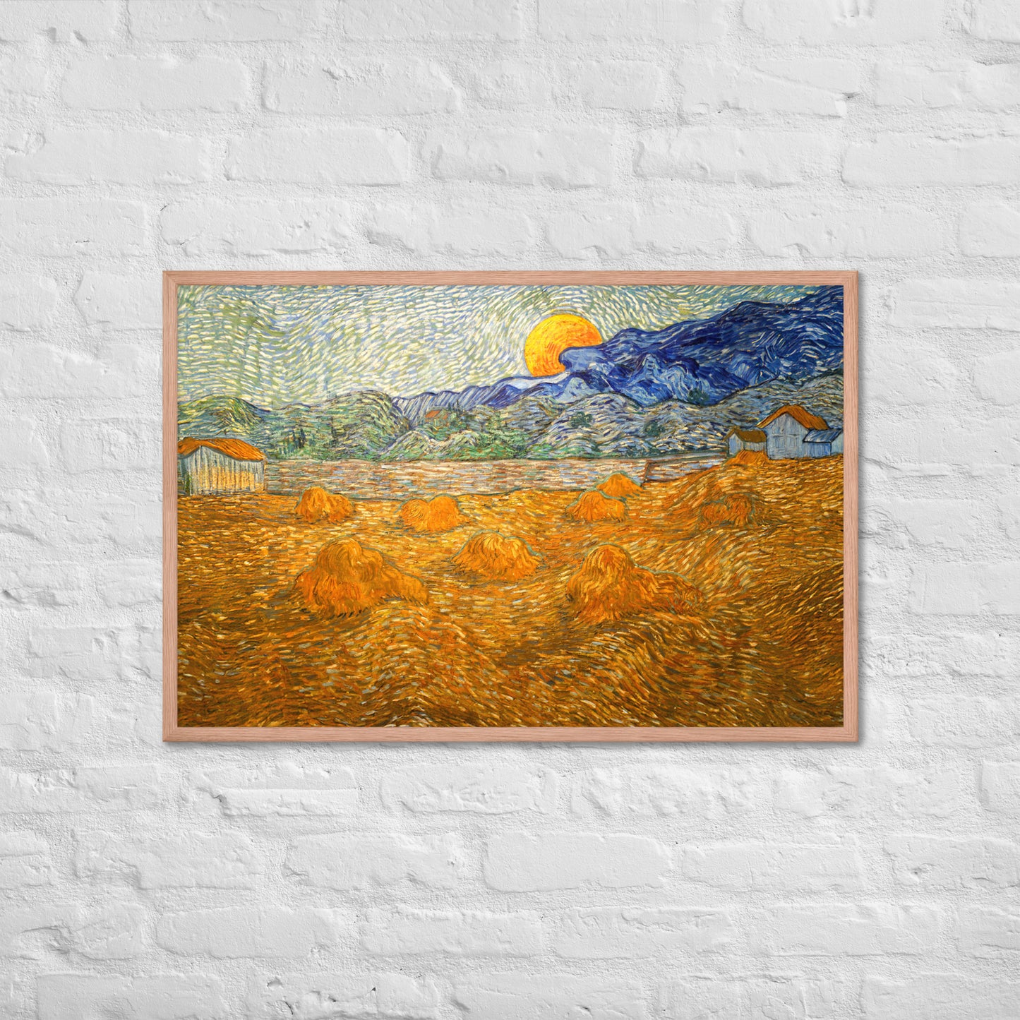 Van Gogh's 'Landscape with Wheat Sheaves and Rising Moon' on a 24"x36" red oak framed poster print on a white brick wall.