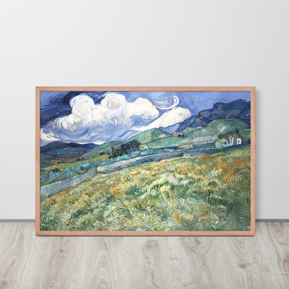 Van Gogh's 'Landscape from Saint-Rémy' on a 24"x36" red oak framed poster print sitting on a wooden floor leaning against a light gray wall.