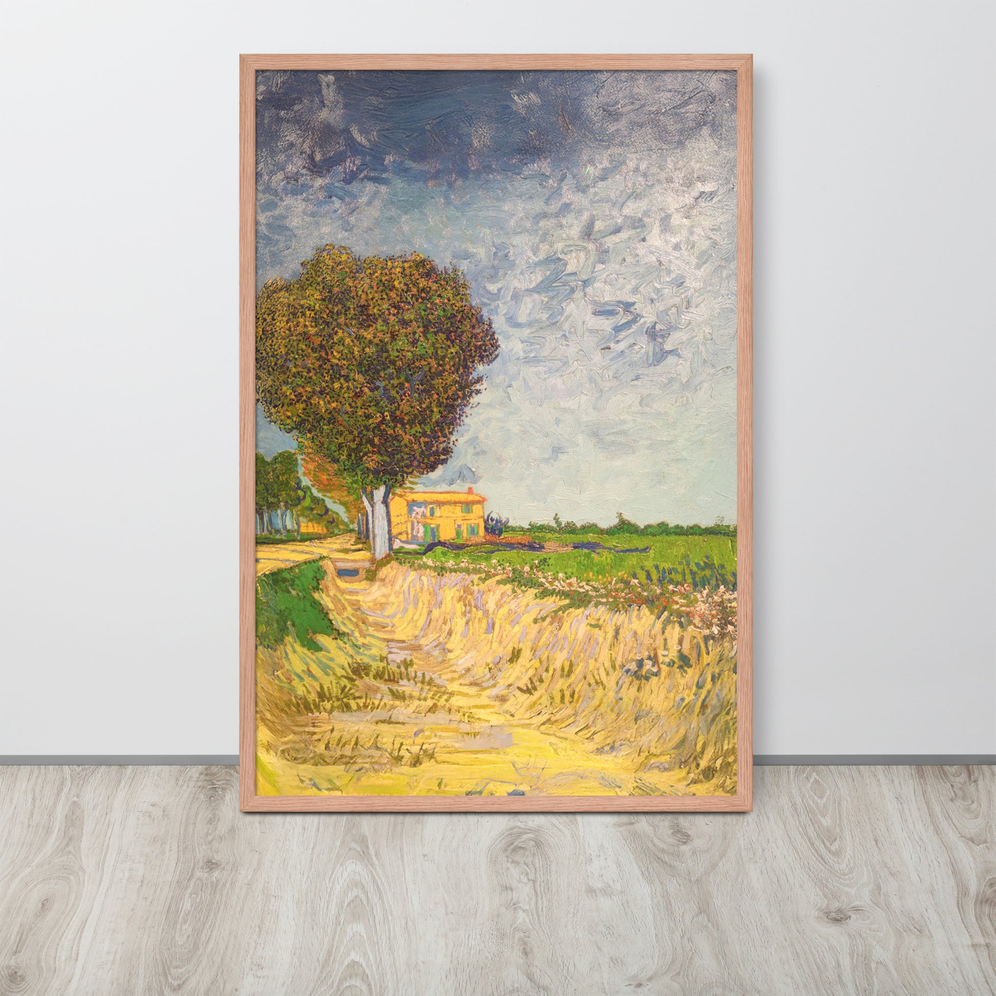 Van Gogh's 'A Lane near Arles' on a 24"x36" red oak framed poster print sitting on a wooden floor leaning against a light gray wall.