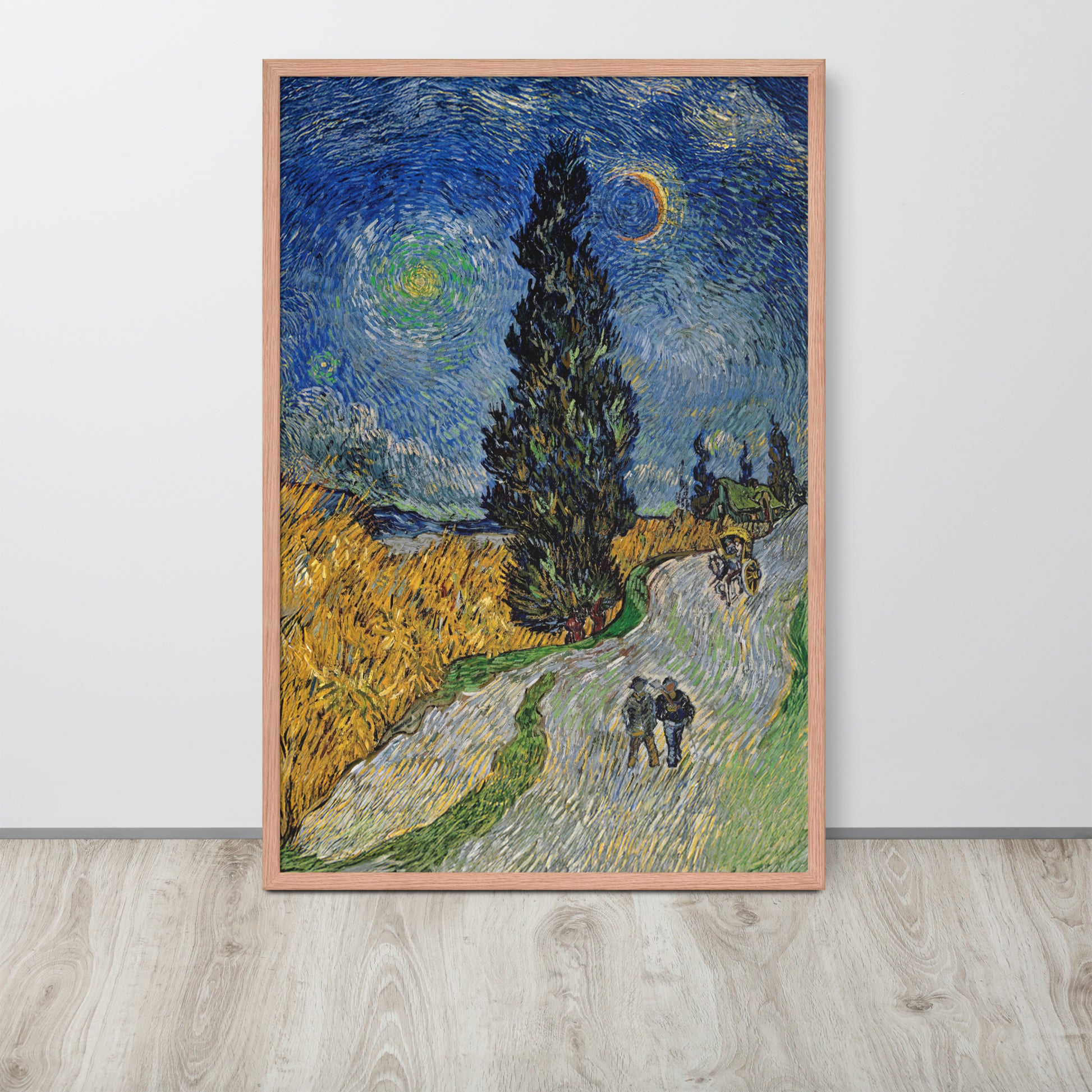Van Gogh's 'Road with Cypress and Star' on a 24"x36" red oak framed poster print sitting on a wooden floor leaning against a light gray wall.
