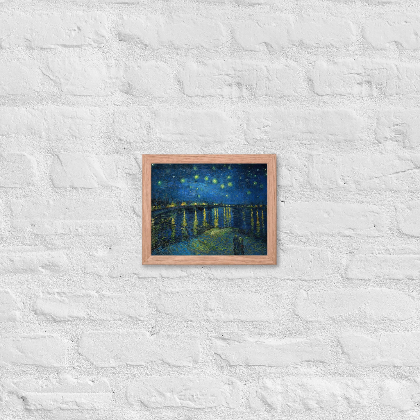 Van Gogh's 'Starry Night Over the Rhone' on a 8"x10" red oak framed poster print on a white brick wall.