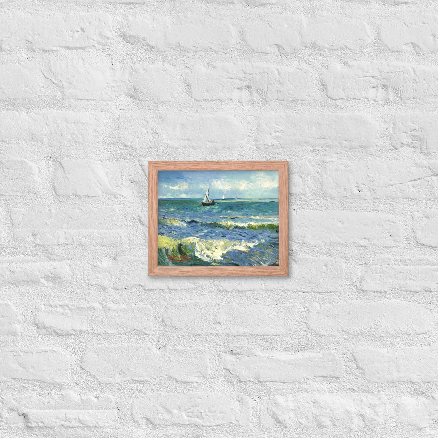 Van Gogh's 'The Sea at Les Saintes-Maries-de-la-Mer' on a 8"x10" red oak framed poster print on a white brick wall.