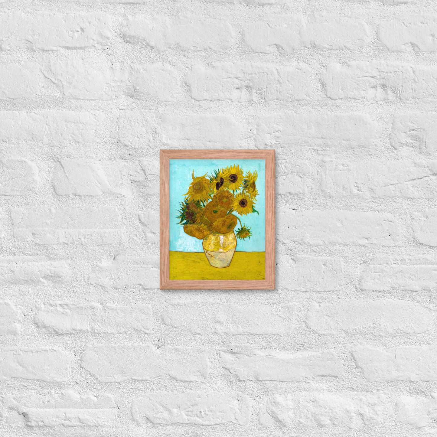 Van Gogh's 'Vase with Twelve Sunflowers' on a 8"x10" red oak framed poster print on a white brick wall.