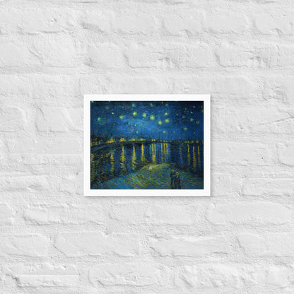 Van Gogh's 'Starry Night Over the Rhone' on a 11"x14" white framed poster print on a white brick wall.
