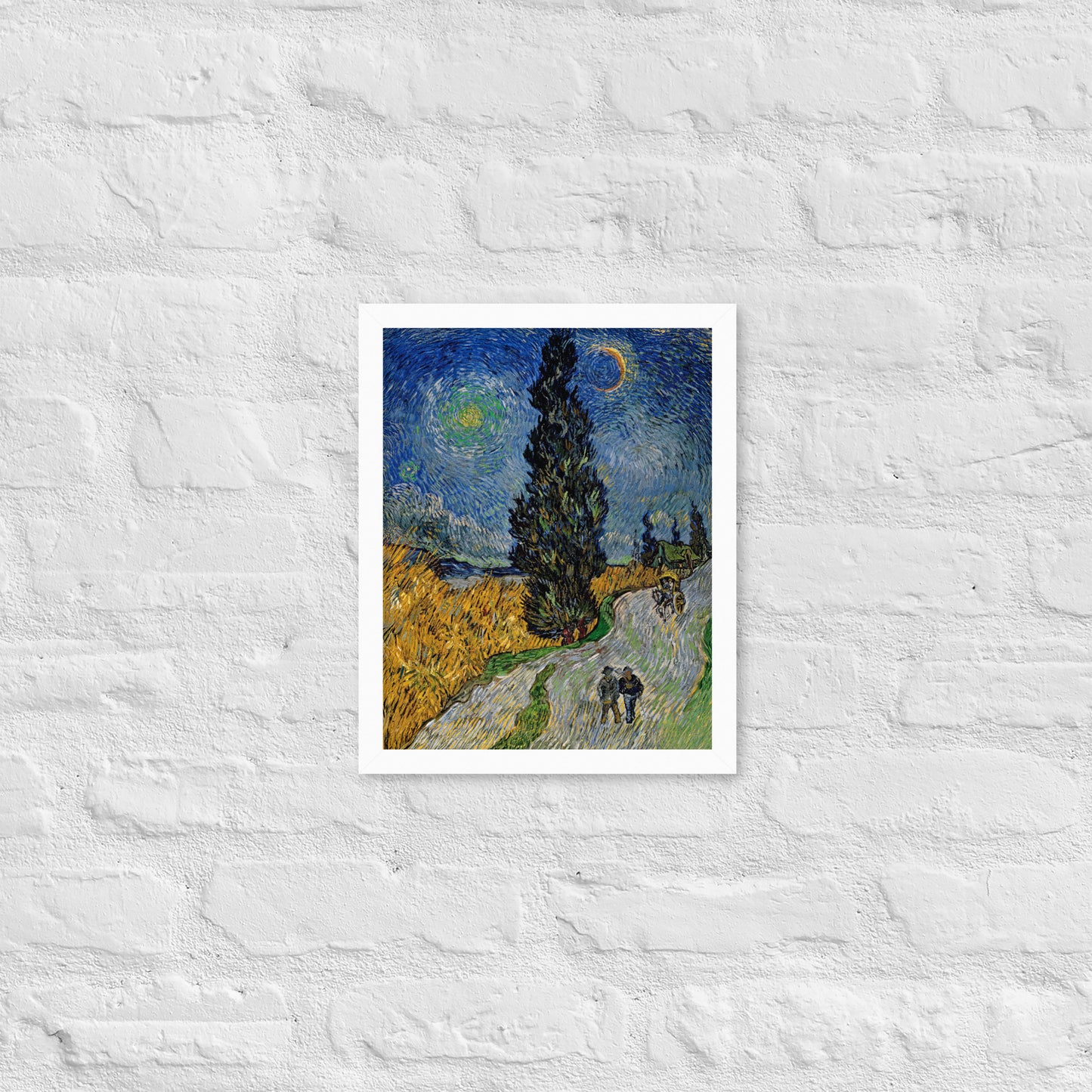 Van Gogh's 'Road with Cypress and Star' on a 11"x14" white framed poster print on a white brick wall.