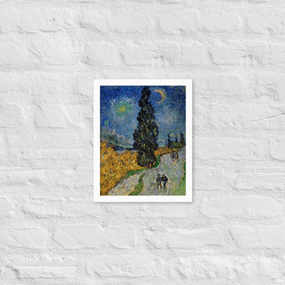Van Gogh's 'Road with Cypress and Star' on a 11"x14" white framed poster print on a white brick wall.