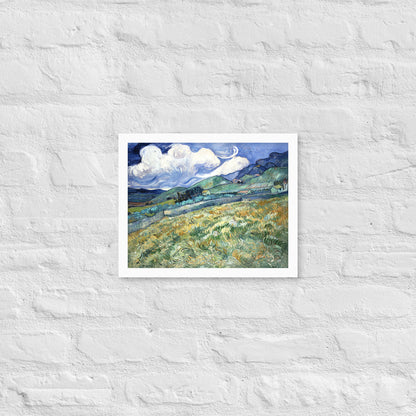 Van Gogh's 'Landscape from Saint-Rémy' on a 11"x14" white framed poster print on a white brick wall.