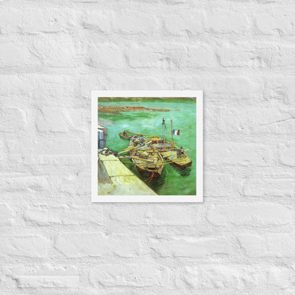 Van Gogh's 'Quay with Men Unloading Sand Barges' on a 12"x12" white framed poster print on a white brick wall.