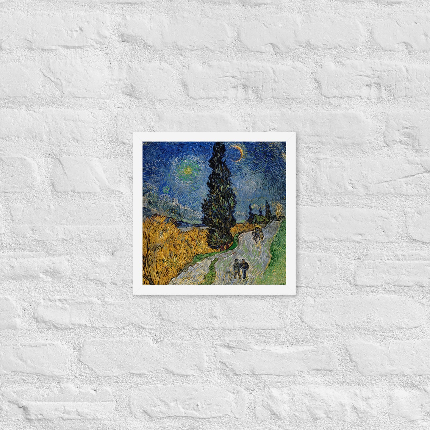 Van Gogh's 'Road with Cypress and Star' on a 12"x12" white framed poster print on a white brick wall.