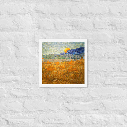Van Gogh's 'Landscape with Wheat Sheaves and Rising Moon' on a 12"x12" white framed poster print on a white brick wall.