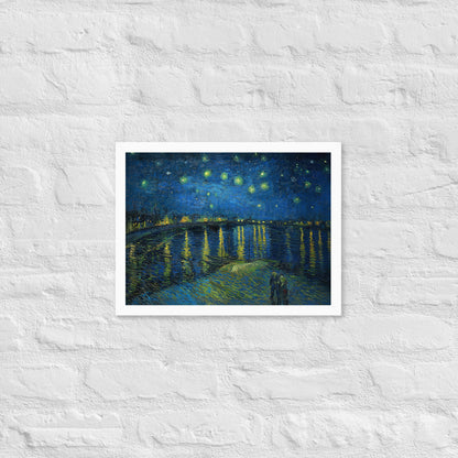 Van Gogh's 'Starry Night Over the Rhone' on a 12"x16" white framed poster print on a white brick wall.