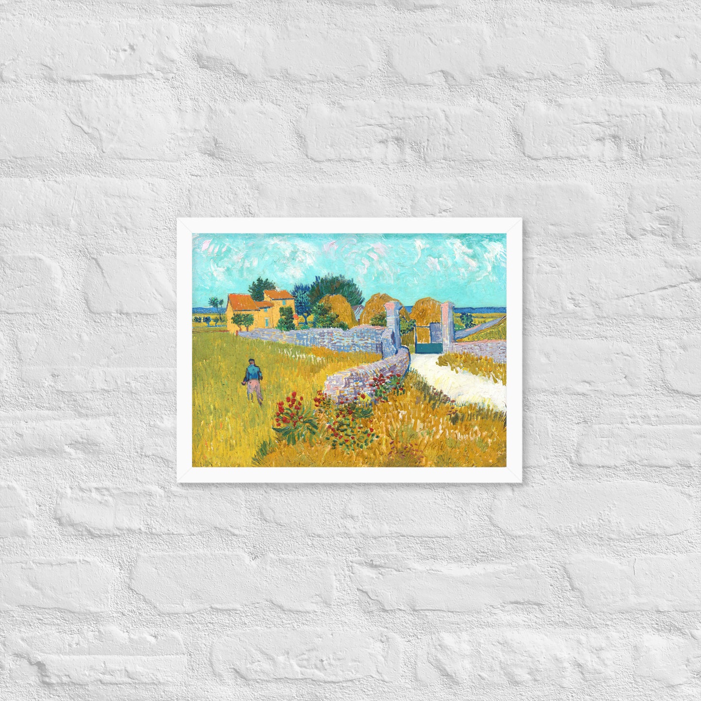 Van Gogh's 'Farmhouse in Provence' on a 12"x16" white framed poster print on a white brick wall.
