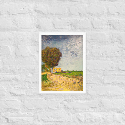 Van Gogh's 'A Lane near Arles' on a 12"x16" white framed poster print on a white brick wall.