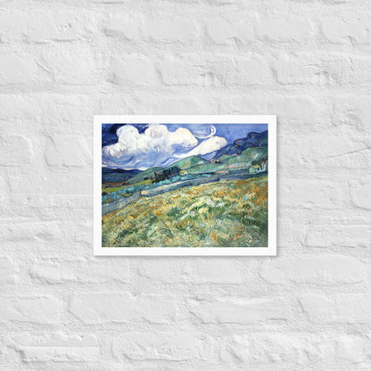 Van Gogh's 'Landscape from Saint-Rémy' on a 12"x16" white framed poster print on a white brick wall.