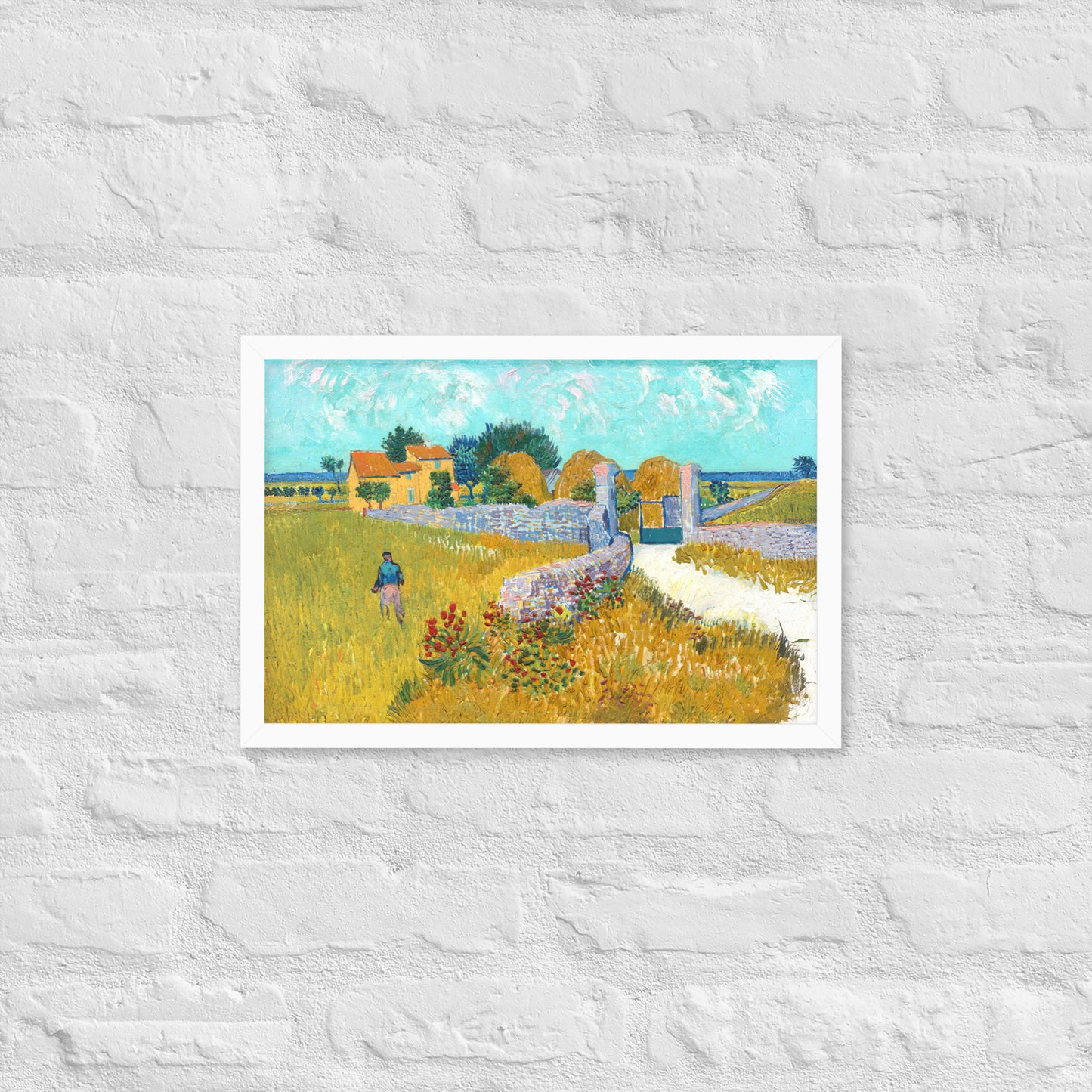 Van Gogh's 'Farmhouse in Provence' on a 12"x18" white framed poster print on a white brick wall.