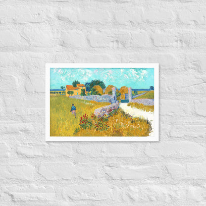 Van Gogh's 'Farmhouse in Provence' on a 12"x18" white framed poster print on a white brick wall.