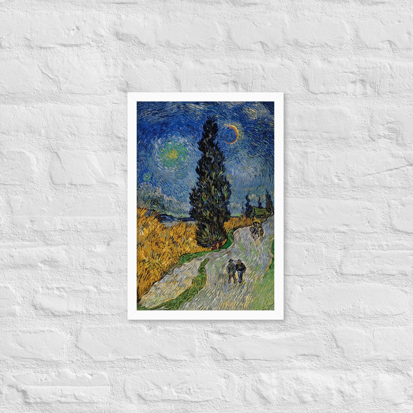 Van Gogh's 'Road with Cypress and Star' on a 12"x18" white framed poster print on a white brick wall.