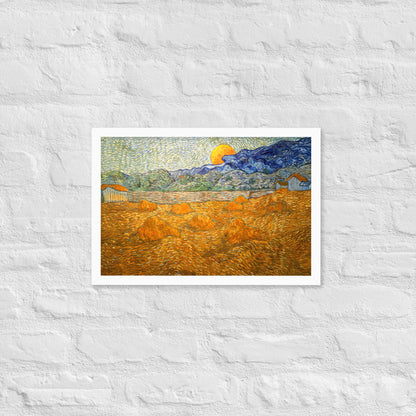Van Gogh's 'Landscape with Wheat Sheaves and Rising Moon' on a 12"x18" white framed poster print on a white brick wall.