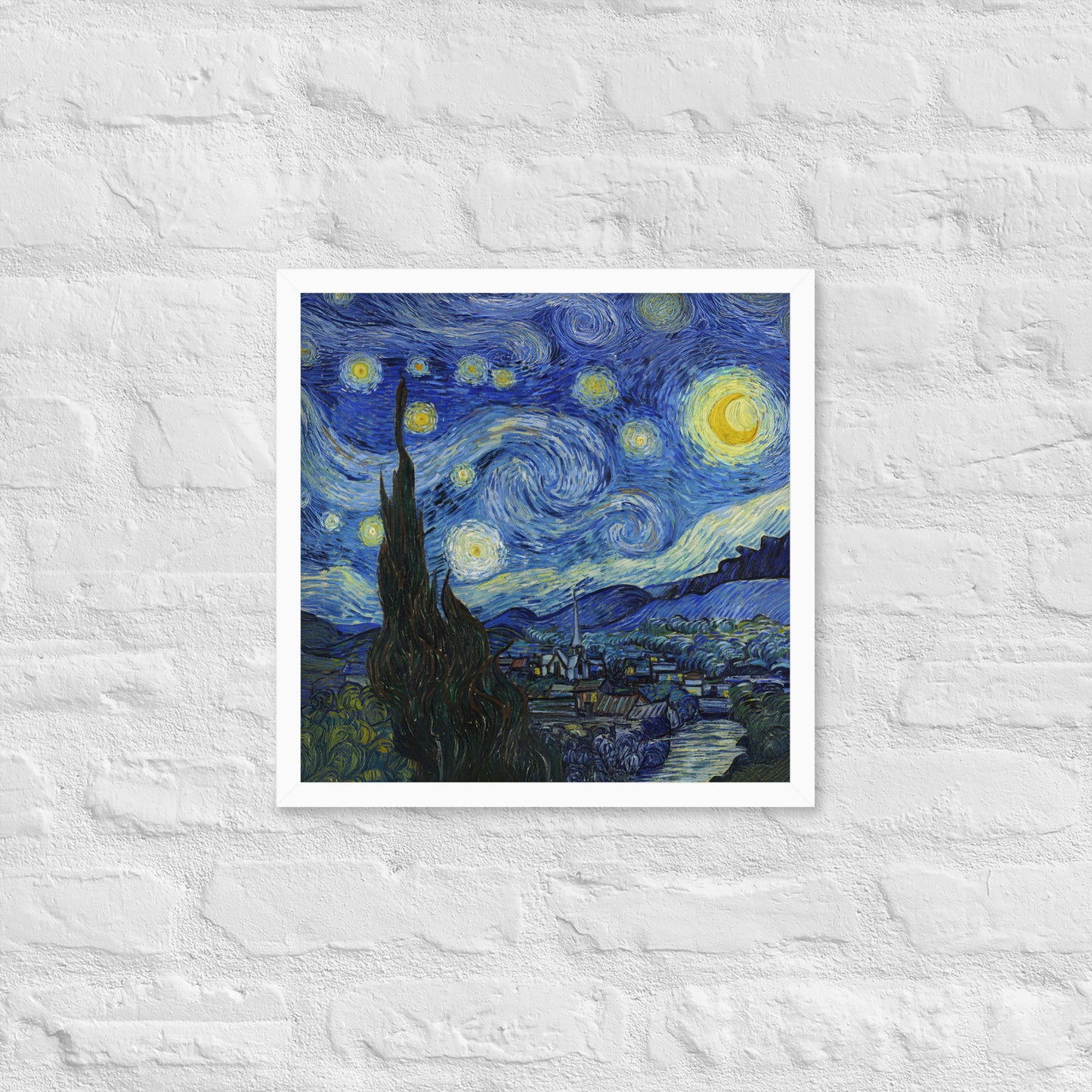 Van Gogh's 'Starry Night' on a 16"x16" white framed poster print on a white brick wall.
