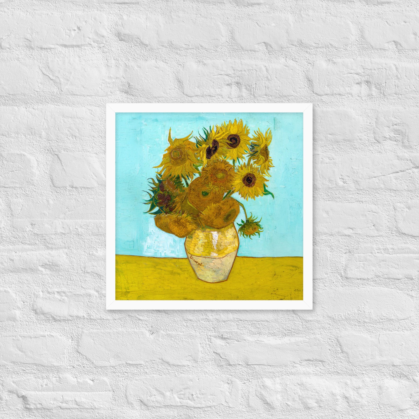 Van Gogh's 'Vase with Twelve Sunflowers' on a 16"x16" white framed poster print on a white brick wall.