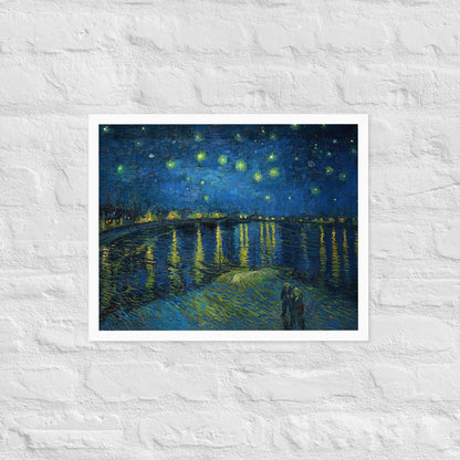 Van Gogh's 'Starry Night Over the Rhone' on a 16"x20" white framed poster print on a white brick wall.