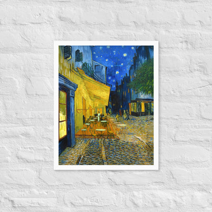 Van Gogh's 'Café Terrace at Night' on a 16"x20" white framed poster print on a white brick wall.