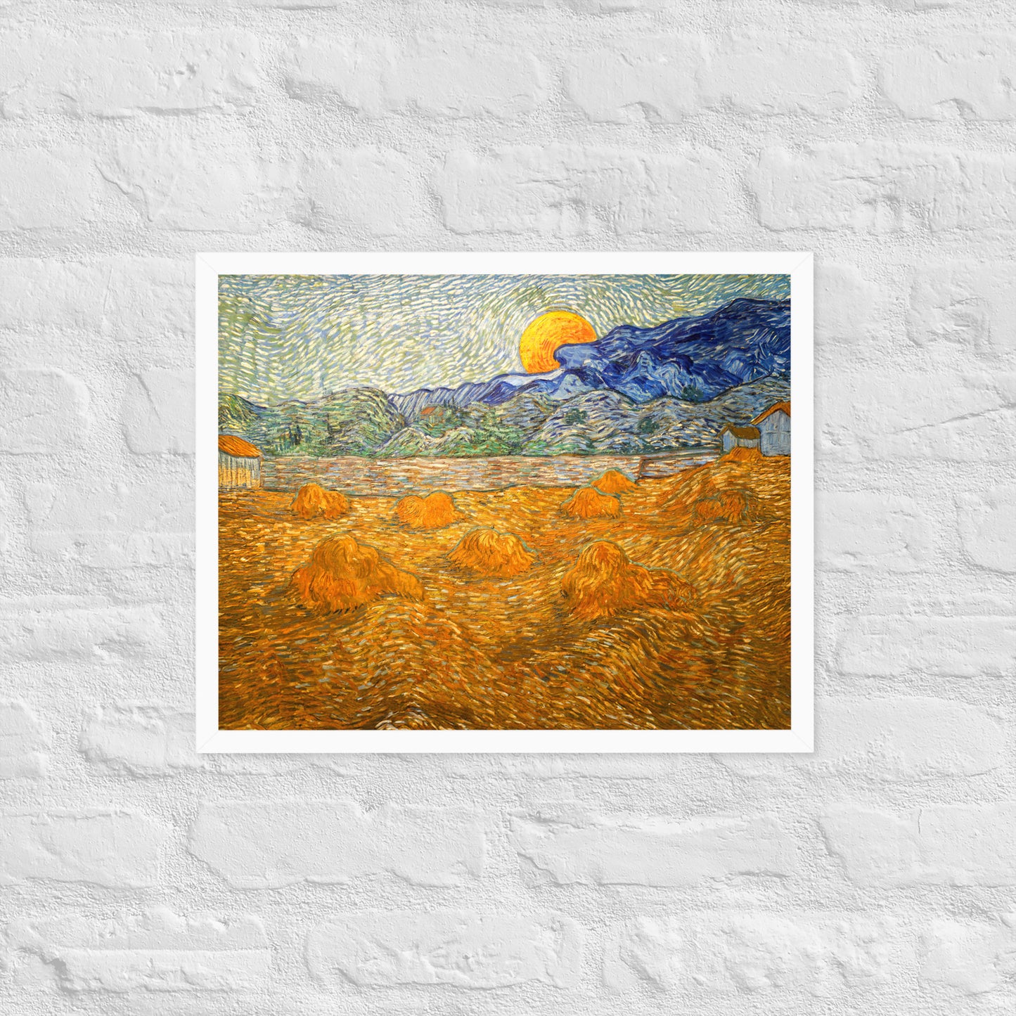Van Gogh's 'Landscape with Wheat Sheaves and Rising Moon' on a 16"x20" white framed poster print on a white brick wall.