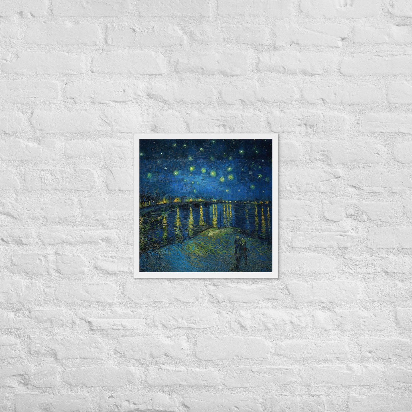 Van Gogh's 'Starry Night Over the Rhone' on a 18"x18" white framed poster print on a white brick wall.