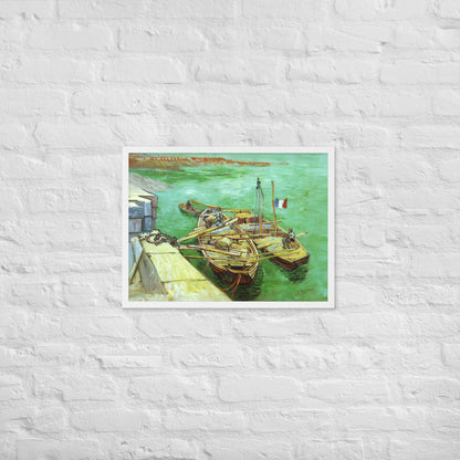 Van Gogh's 'Quay with Men Unloading Sand Barges' on a 18"x24" white framed poster print on a white brick wall.