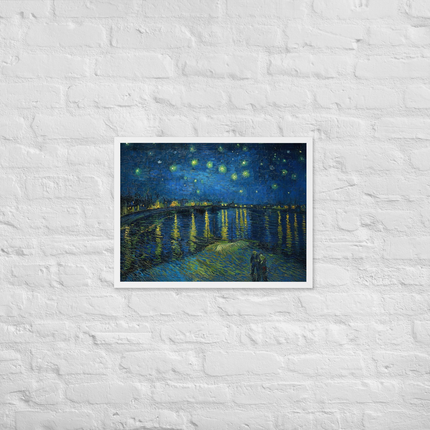 Van Gogh's 'Starry Night Over the Rhone' on a 18"x24" white framed poster print on a white brick wall.