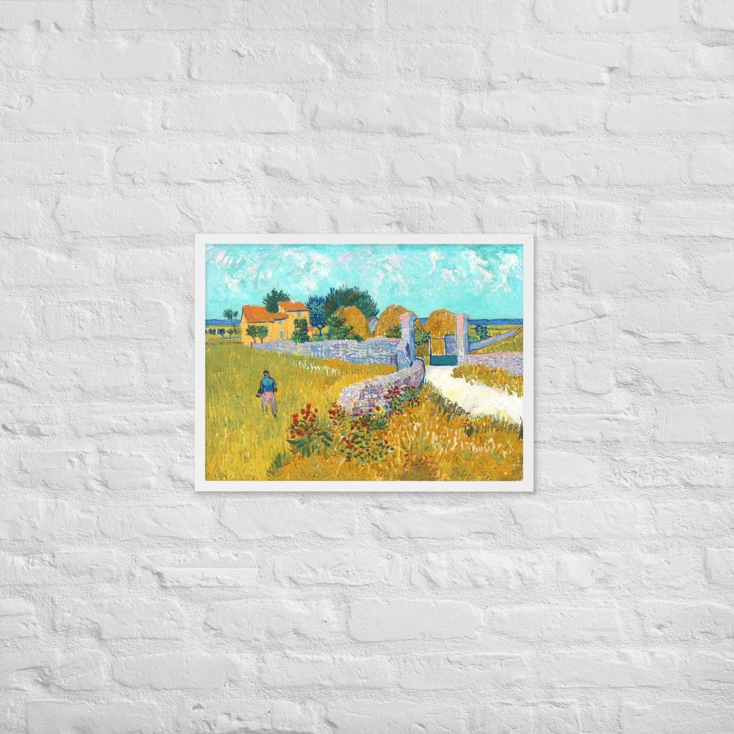Van Gogh's 'Farmhouse in Provence' on a 18"x24" white framed poster print on a white brick wall.