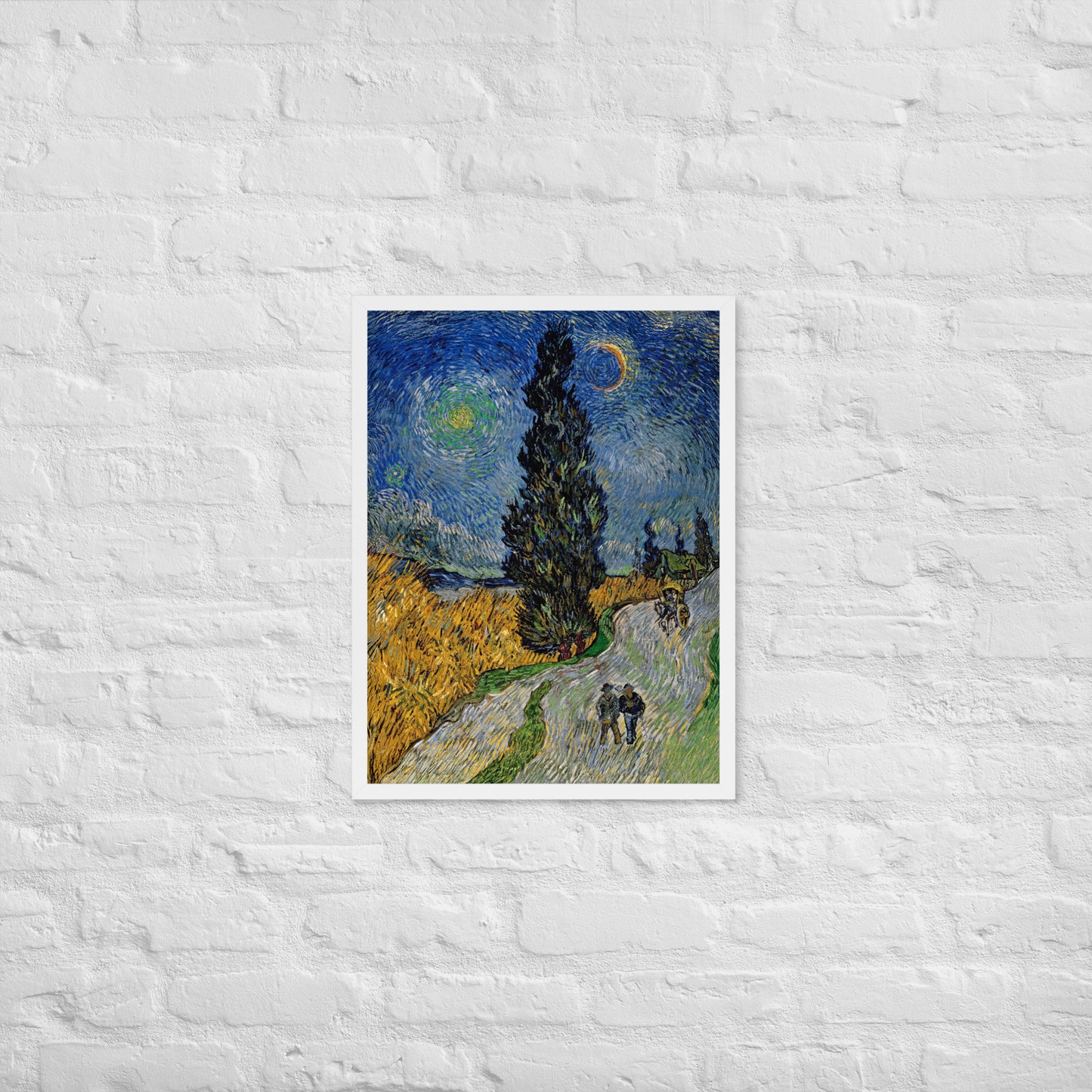 Van Gogh's 'Road with Cypress and Star' on a 18"x24" white framed poster print on a white brick wall.