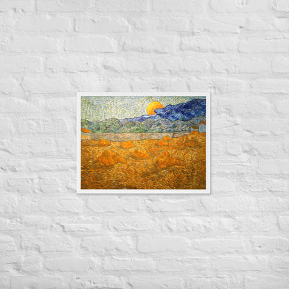 Van Gogh's 'Landscape with Wheat Sheaves and Rising Moon' on a 18"x24" white framed poster print on a white brick wall.