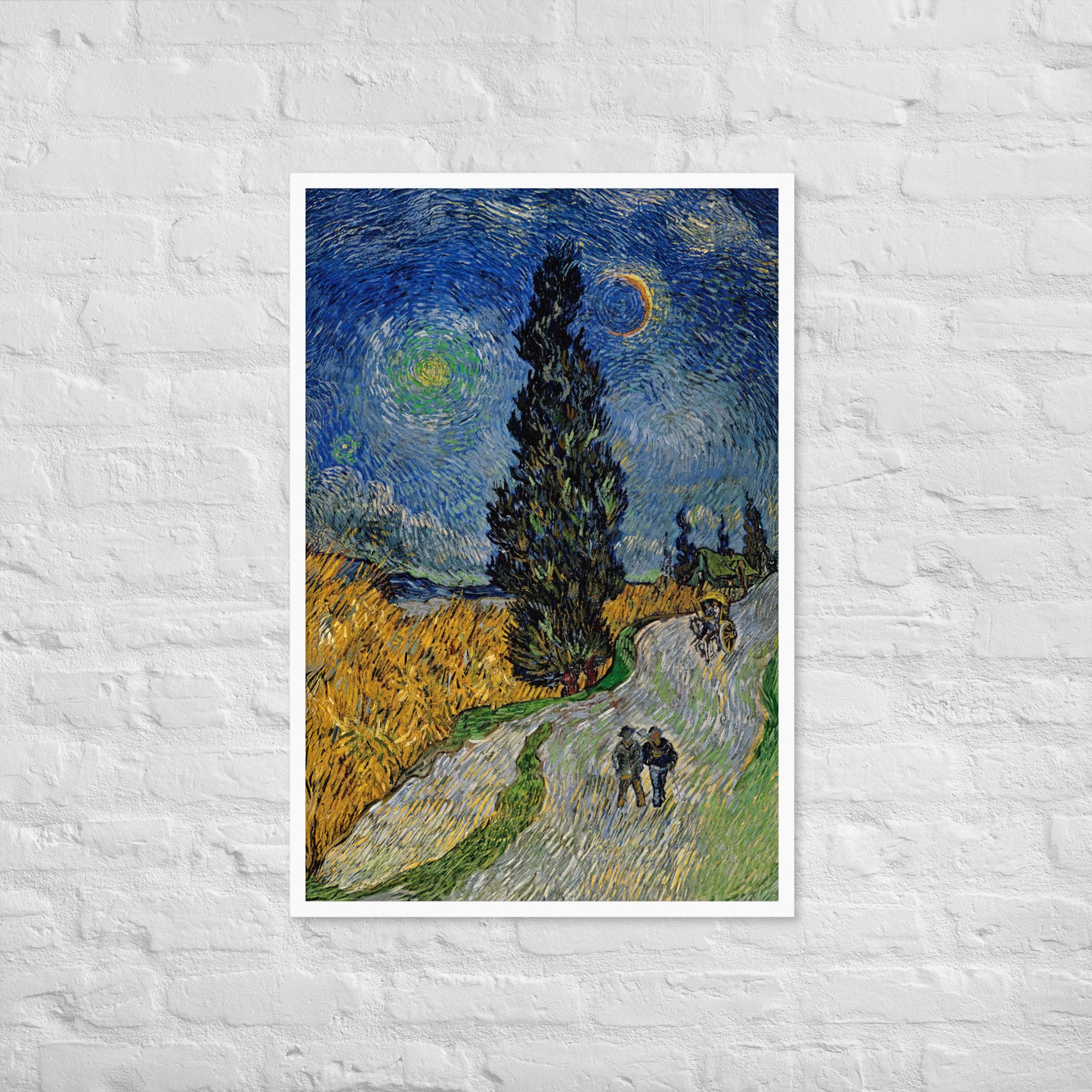 Van Gogh's 'Road with Cypress and Star' on a 24"x36" white framed poster print on a white brick wall.